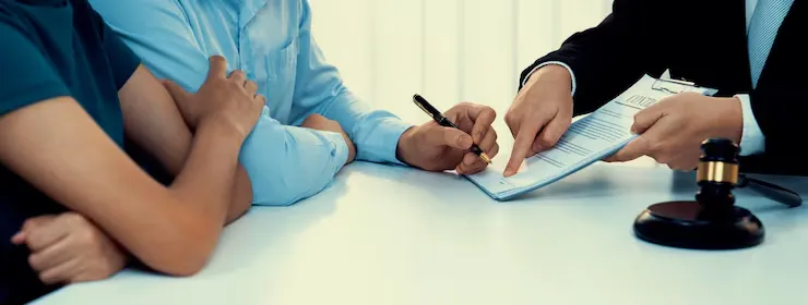 A lawyer reviewing legal documents with clients